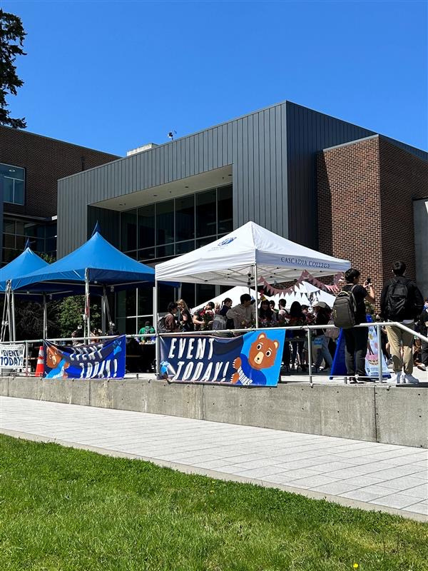 several tents are set up in front of a building with banners that say event today