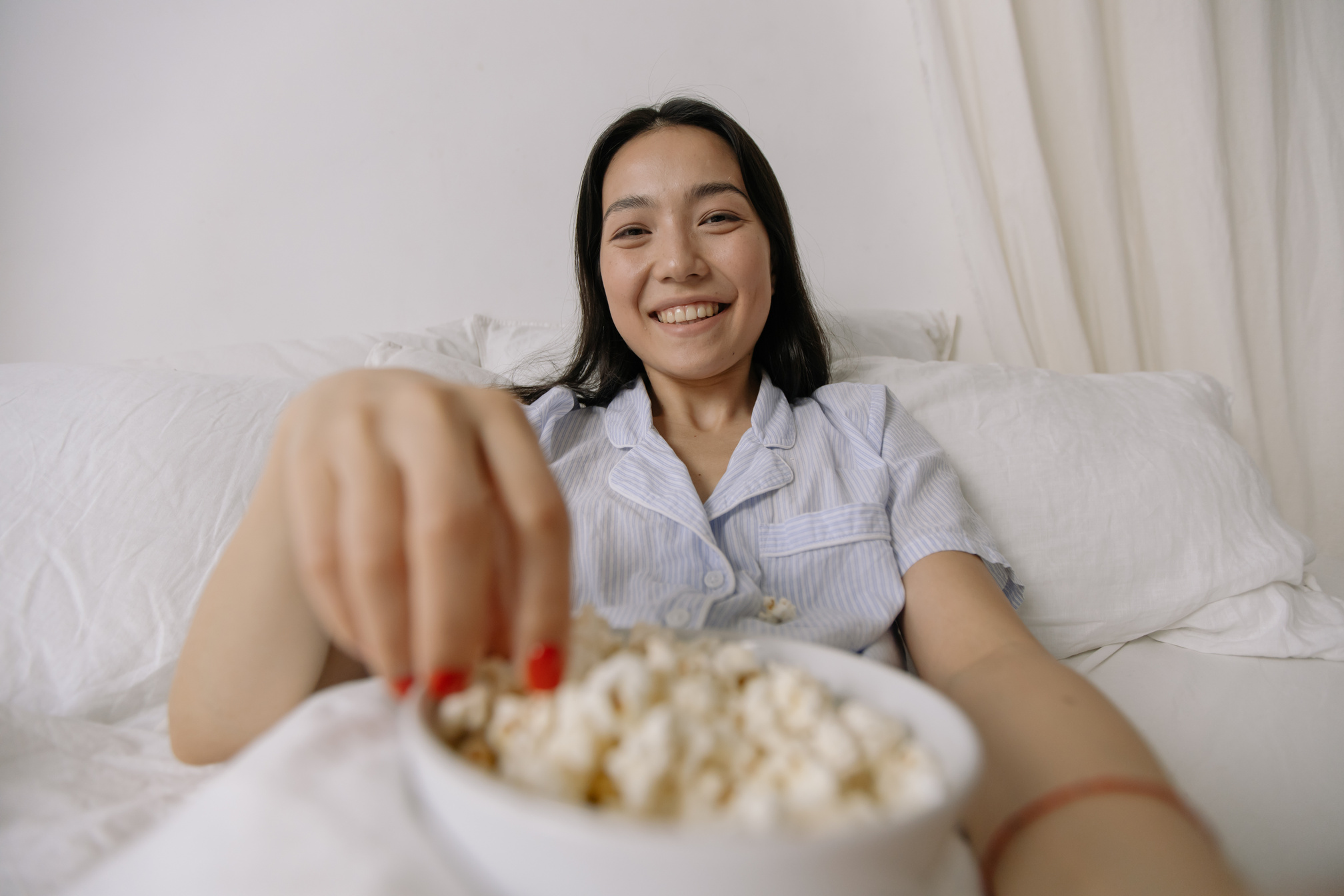 woman eating popcorn in bed - popcorn stock videos & royalty-free footage