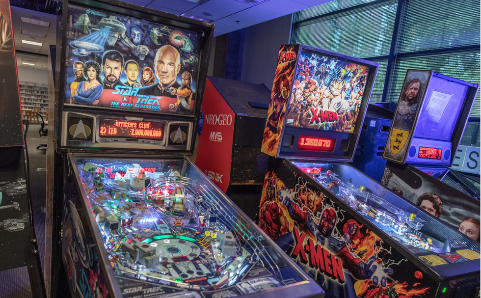 two pinball machines are lined up next to each other