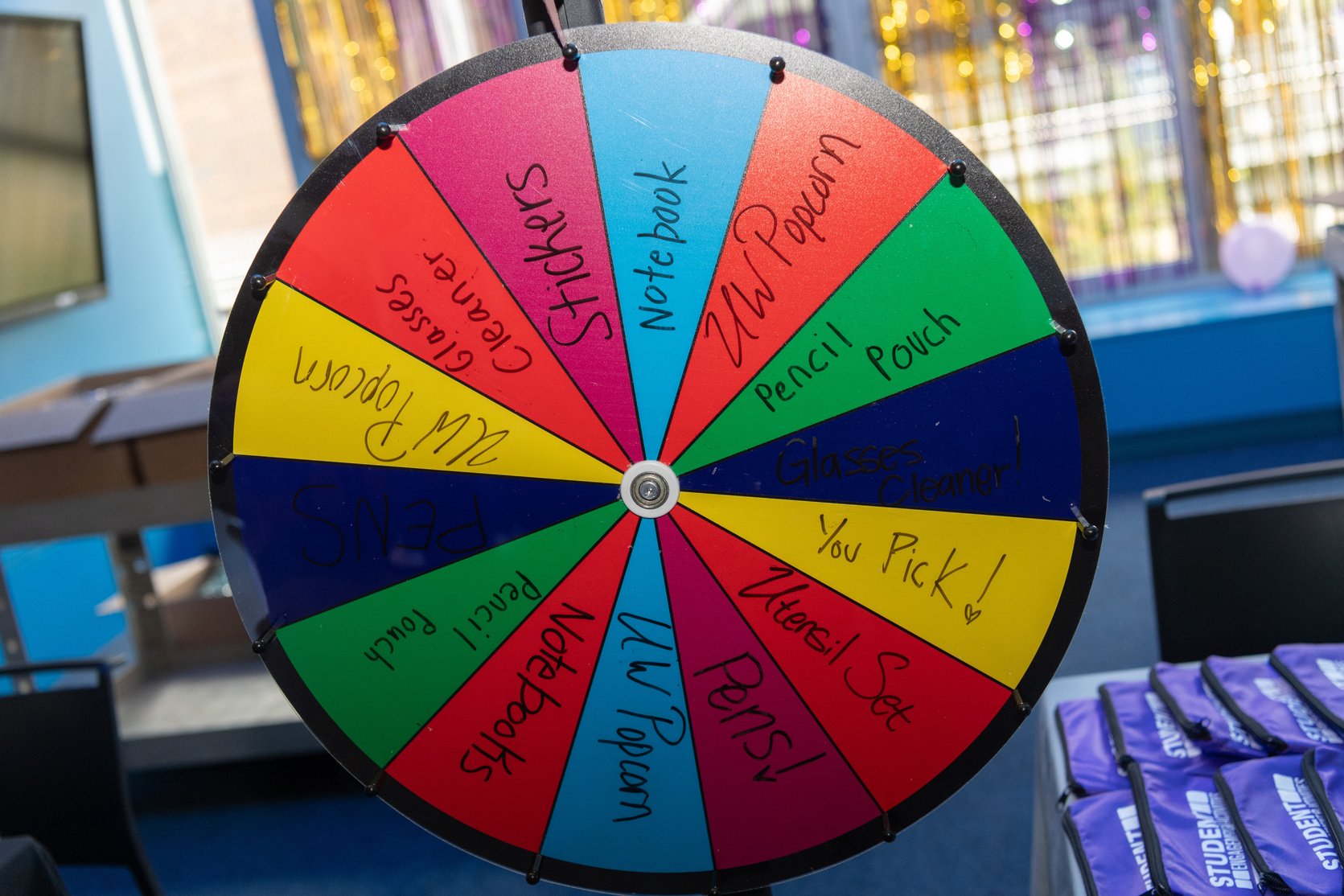 a spinning wheel of with many different example prize words written on it
