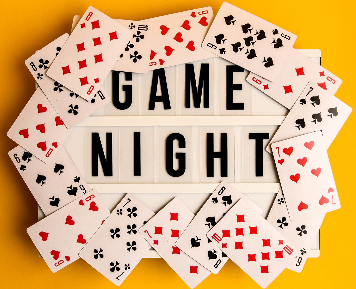game night sign with playing cards on yellow background