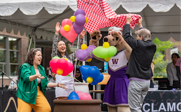 a group of people with balloons in front of them