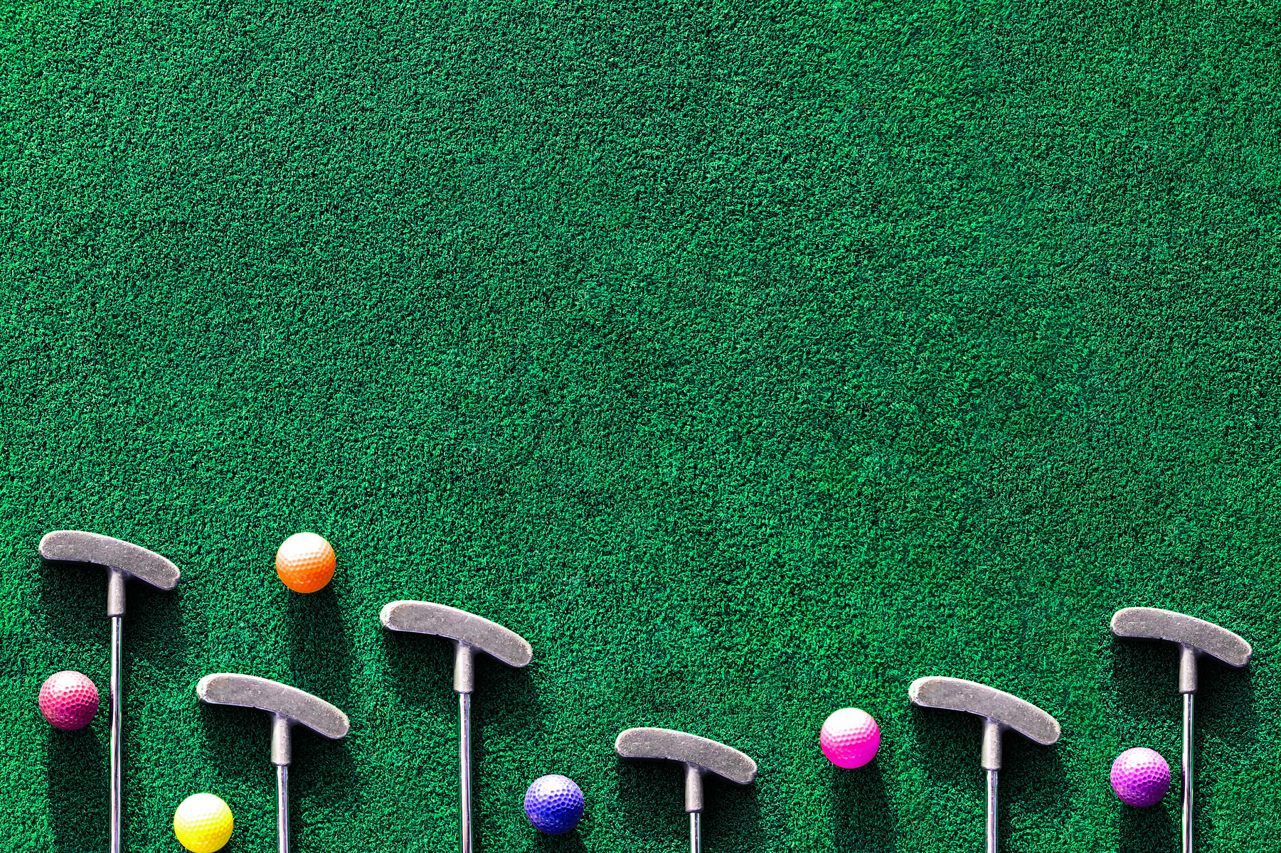 colorful golf balls on the green grass